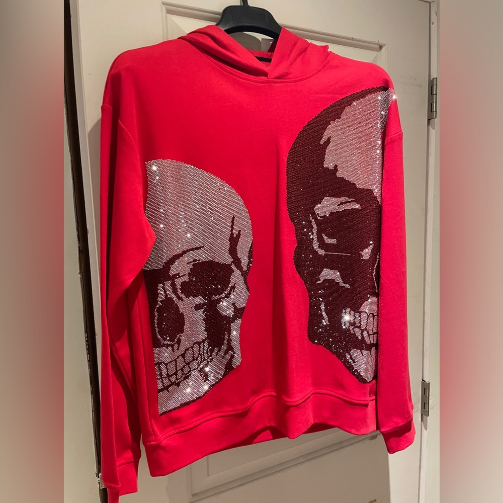 Men’s size Large red hoodie with sparkly skull emblems on front.